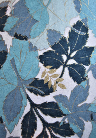 Close-up of Japanese chiyogami paper leaves in shades of blue with accents in gold