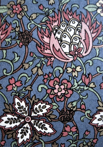 Close-up of Japanese chiyogami paper with white & pink floral design on blue background with gold accents