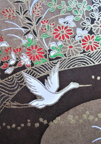 Japanese chiyogami, yuzen, mulberry, rice paper with white cranes on brown floral background with gold accents.